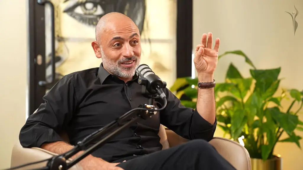 a man sitting in a chair with a microphone